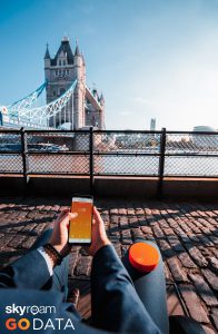 person holding skyroam solis looking out at the london bridge